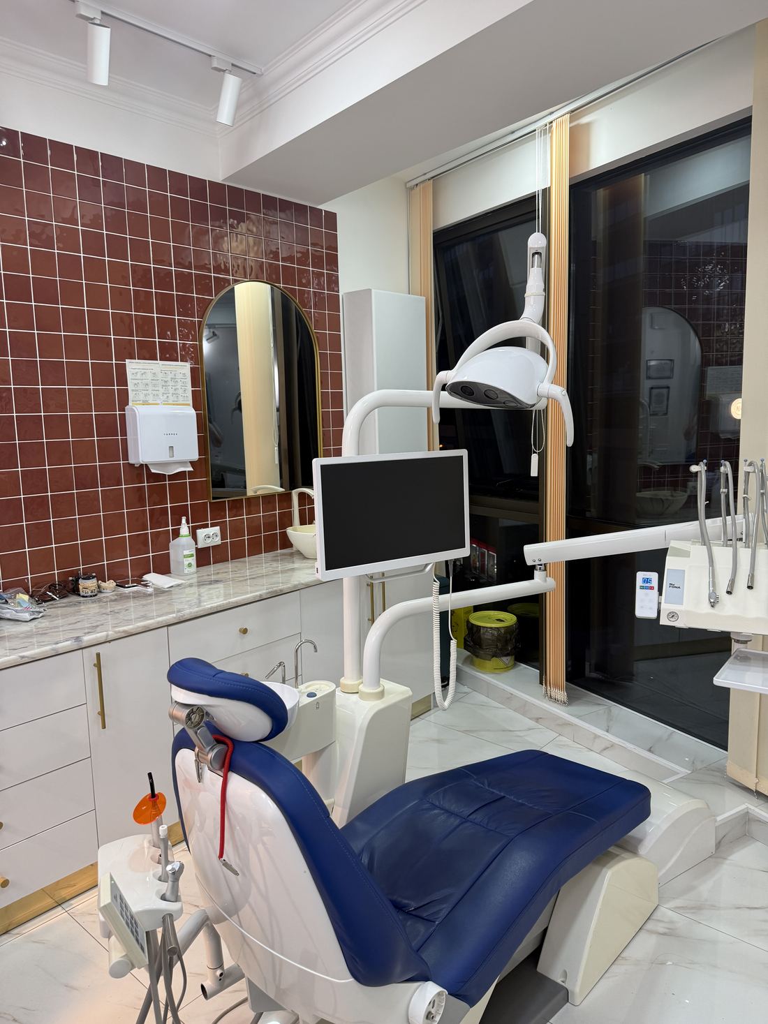 Treatment room with a blue dental chair