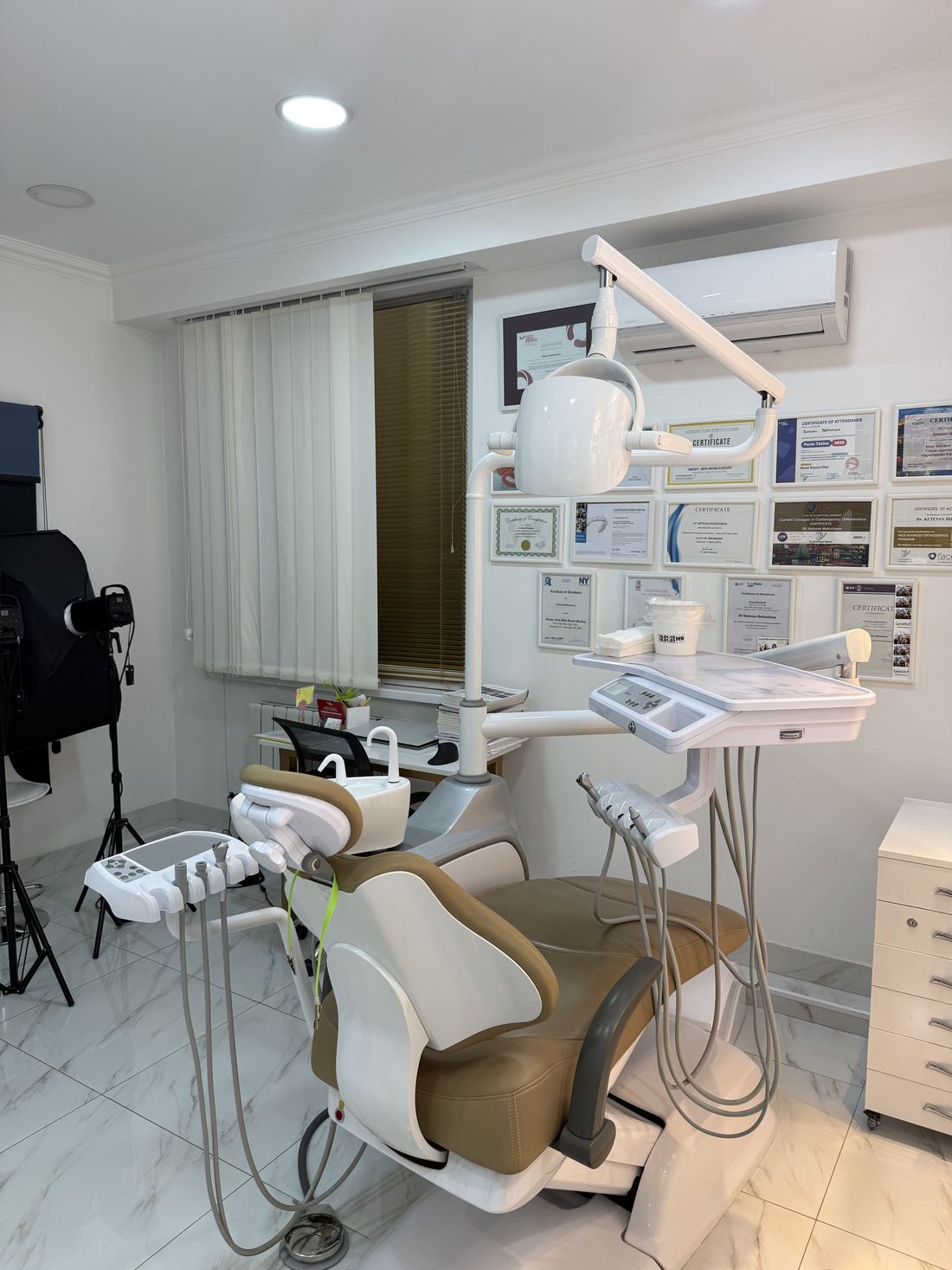 Treatment room with doctors' certificates on the wall